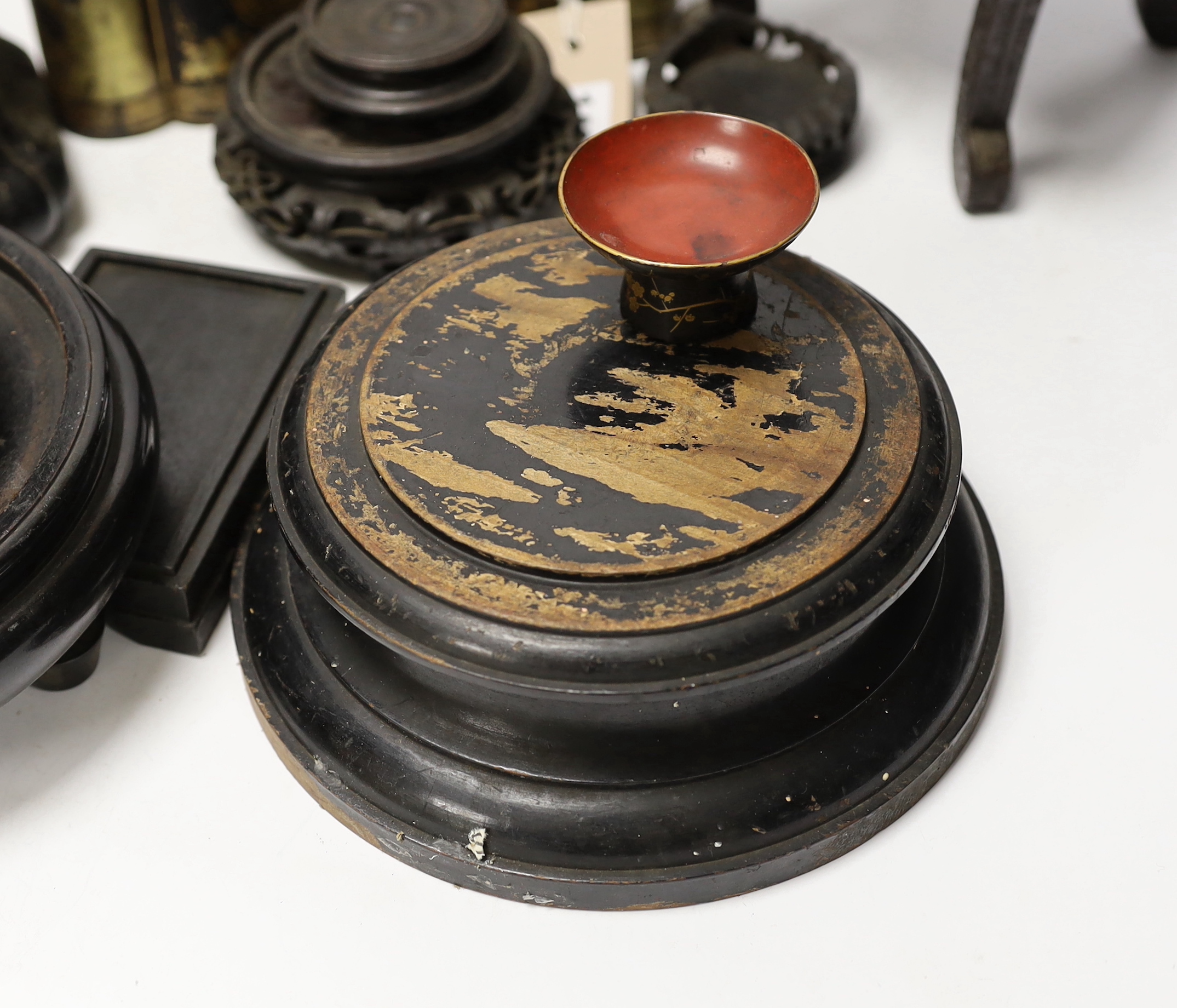 A Chinese lacquer and gilt casket together with various carved stands, largest 17cm high